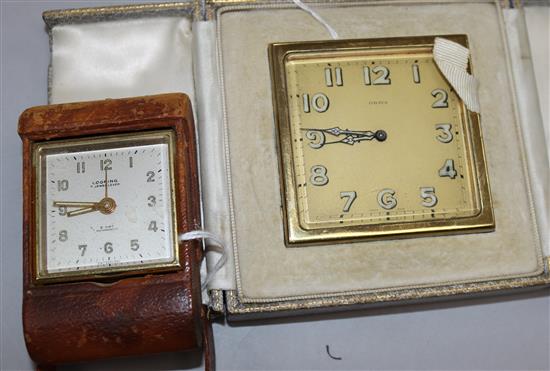 A Swiss gilt-metal travelling alarm clock in Asprey folding leather case and another smaller leather clock